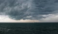 The calm before the storm. Dark dense clouds over the wavy sea Royalty Free Stock Photo