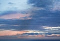 Calm sunset or sunrise over the Mediterranean sea, the sun shining through soft blue and pink clouds Royalty Free Stock Photo