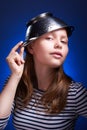 Calm teen girl with a colander on her head Royalty Free Stock Photo