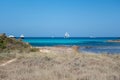 calm torquoise Balearic sea in the sunny day with moored boats Formentera beach