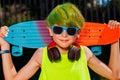 Close-up portrait of a boy with skateboard green hair headphones Royalty Free Stock Photo