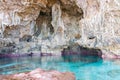 Calm turquoise colored water in pool in limestone cave on coast Royalty Free Stock Photo