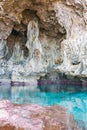 Calm turquoise colored water in pool in limestone cave on coast Royalty Free Stock Photo