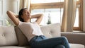 Calm Vietnamese girl relax at home couch breathing air Royalty Free Stock Photo