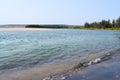 Calm Ware Beach with Clean Blue Water, Trees and an Island