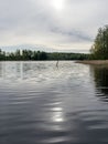 Calm water, beautiful reflections, forest silhouette on the horizon