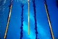 Calm water on empty swimming pool, dark lanes marks visible floor Royalty Free Stock Photo