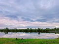 Calm water on lake. Storm Rainy weather. Summer overcast sky. Dramatic landscape, cloudy day Royalty Free Stock Photo