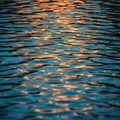 Surface with gentle waves reflecting golden sunlight creating a Royalty Free Stock Photo