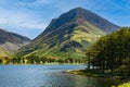 Calm waters of Buttermere with the tall mountain of Fleetwith Pike and the Honnister Pass behind (Lake District Royalty Free Stock Photo