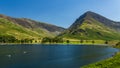 Calm waters of Buttermere with the tall mountain of Fleetwith Pike and the Honnister Pass behind (Lake District Royalty Free Stock Photo