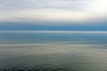 Calm Waters and Distant Clouds on a Lake Shore