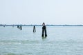 Calm waters with navigational poles in serene seascape Royalty Free Stock Photo