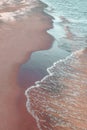 Calm waves running over sand coast