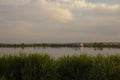 The calm wide river carries its waters under the morning sky