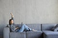 Calm woman lying on cozy sofa relaxing on weekend, peaceful female rest with eyes closed hands over head on couch, happy girl Royalty Free Stock Photo