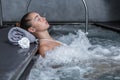 Calm woman resting in bubbling pool