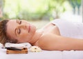 Calm woman, sleeping and relaxing with towel for spa, zen or treatment on massage table, hotel or outdoor resort. Face Royalty Free Stock Photo