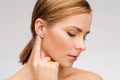 Calm woman touching her ear Royalty Free Stock Photo