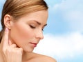 Calm woman touching her ear Royalty Free Stock Photo