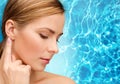 Calm woman touching her ear Royalty Free Stock Photo