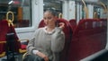 Calm woman waiting departure train with luggage. Short hair girl sitting wagon Royalty Free Stock Photo