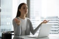 Young woman employee meditating practicing yoga at workplace Royalty Free Stock Photo