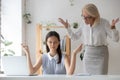 Senior businesswoman shocked by calm employee meditating Royalty Free Stock Photo