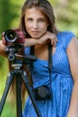 Calm young woman with camera on