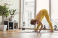 Calm young woman doing yoga in flat