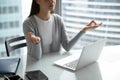 Calm young woman employee practicing simple meditation at office table