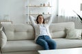 Calm young woman relax on couch taking nap at home Royalty Free Stock Photo