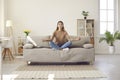 Calm woman practice yoga meditate on couch