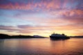 A Calmac ferry entering Oban harbour in the Scottish highlands during sunset Royalty Free Stock Photo