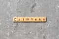 Calmness word written on wood block. calmness text on cement table for your desing, concept