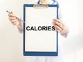 Calories, concept of word on paper in doctor hand Royalty Free Stock Photo