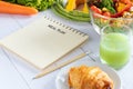 Calories control, meal plan, food diet and weight loss concept. meal plan writing on notebook planner with salad, fruit juice Royalty Free Stock Photo