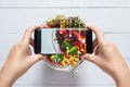 Calories counting and food control concept. woman using application on smartphone for scanning the amount of calories in the food Royalty Free Stock Photo