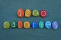 1200 calories diet text composed with multi colored stone letters and numbers over green sand Royalty Free Stock Photo