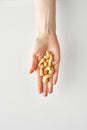 100 calories portion of cashews in a woman`s hand isolated on a white background, healthy food and lifestyle