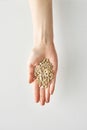 100 calories portion of snack of sunflower seeds in hand isolated on white background, healthy food and lifestyle