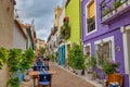 Street in the old town of Calpe with colorful houses and restaurant terraces, Alicante, Spain.