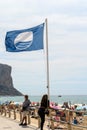 Calpe, Valencia, Spain, April, 23, 2022: Blue flag symbol of clean water on an Alicante beach