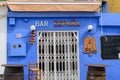 Calpe, Valencia, Spain. August 4, 2021: Facade of a closed Spanish bar with a grille on the door