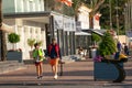 Two boys walking in the commercial area of Port Adriano, the famous nautical club promenade