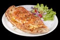 Calzone pizza with tomato sauce, bacon, ham, stewed mushrooms and yellow cheese on a plate