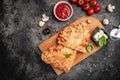 Calzone pizza with tomatoes, mozzarella, mushrooms and fresh basil, italian calzone vegetarian pizza, Food recipe background. Royalty Free Stock Photo