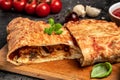 Calzone pizza with tomatoes, mozzarella, mushrooms and fresh basil, italian calzone vegetarian pizza, Food recipe background. Royalty Free Stock Photo