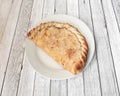 calzone is a specialty of Italian cuisine made in a similar way to pizza