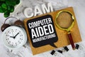 CAM Computer Aided Manufacturing acronym with alarm clock and magnifying glass, technology and communication concept background Royalty Free Stock Photo
